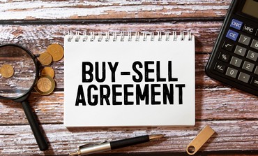 text Buy-Sell Agreement on white paper