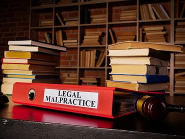 Documents about legal malpractice in the red folder.