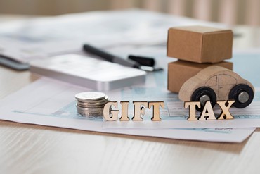 Word Gift Tax composed of wooden letters.