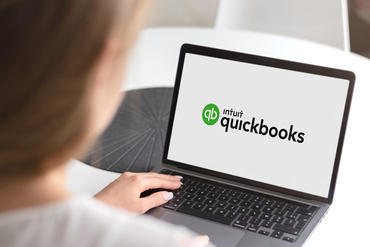 Notebook with Intuit Quickbooks logo. 